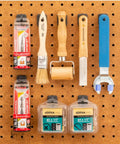 Hang Tight Pegboard C Hooks For Tools Heavy Duty Pegboard Hooks With Locking Design holding various tools and packaging on brown pegboard.