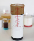 Two Cup Adjustable Measuring Cup with grippy rotating body filled with peanut butter, showing measurement markings.