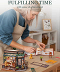 Woman assembling One Eighteen Scale Coffee Bar Dollhouse Kit With Led Lights Diorama Miniature House Building Kit For Adults.