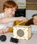 Child building FM radio kit from "Build Your Own FM Radio Kit For Kids And Teens Ages 8 To 14 STEM Toys Fun DIY Electronics Snap Circuits Style Learn Electronics While Building And Testing Radio Circuits Classic Wood Edition" with wooden box and antenna.
