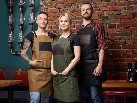 Chefs wearing Black Canvas And Leather Apron For Chefs Bartenders Baristas Barbers And Grill Masters Handmade In USA