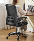 Person sitting on an Ergonomic Office Chair With Adjustable Lumbar Support And Breathable Mesh Flip Up Armrests All Day Cozy Comfort For Home Or Office Adjustable Height Back Supporting Task Chair Built For Long Hours Black at a home desk