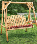 Wooden swing bench with red floral cushion in garden setting, perfect for outdoor relaxation and leisure.