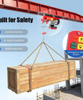 Shop Certified Electric Hoist With Wireless Remote And Twelve Meter Steel Rope 600kg Motorized Winch lifting a wooden crate with a remote.
