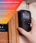 Hand using MR160 Imaging Moisture Meter with IGM Tech on wooden surface, display showing moisture level.