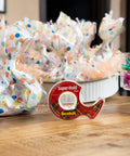 Super Hold Tape With 50 Percent More Adhesive, Clear Finish, 2 Rolls, Dispenser Ready on wooden table with gift bags