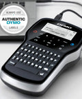 Grab And Go Portable Label Maker With Rechargeable Battery And Qwerty Keyboard on desk with laptop, showing display and keys.