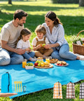 Family enjoying picnic on Portable 57x60 Inch Picnic Blanket Waterproof Sandproof Quick Dry Beach Mat with accessories displayed