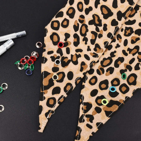 Colorful Grommet And Eyelet Kit with 680 pieces in 17 colors on leopard print fabric for DIY projects