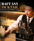 Ultimate Home Bar Mixology Kit With Stand 15 Piece Silver Bar Tool Set cocktail tools on bar with bartender in background.