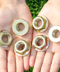 Heavy Duty Hex Flanged Spindle Blade Nuts Engineered For Slick Hella Smooth Operation On Cub Cadet Mtd Toro And Troy Bilt Zero Turn Mowers Providing Killer 5/8 Inch 18 Thread Fitment Two Pack displayed in hands.