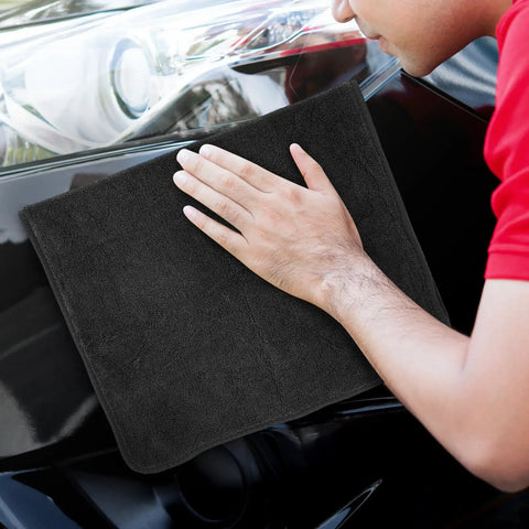 Person using Super Absorbent Microfiber Car Drying Towel Thickened Lint Free Auto Wash Cloth on car surface.