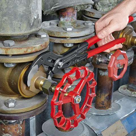Using Cobra XL Water Pump Pliers with one-handed adjustment on industrial valve, showing grip and fine adjustment features.