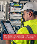 Technician using tablet in front of industrial control panel with IMACP02 Duplex Three Prong Modular Outlet DIN Rail Mount AC Receptacle
