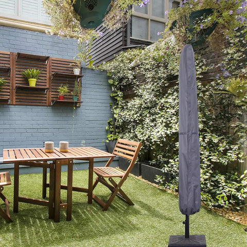 Patio Umbrella Cover With Rod For 7 To 11 Foot And 15 Foot Double Sided Umbrellas Built Tough With 600D Oxford Fabric Waterproof Zippered Weatherproof Gray covering an umbrella in a garden setting.