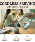 Elite Gourmet Mint Glass Electric Kettle 1L BPA-Free Fast Boil pouring water into a cup with cordless design and safety features.