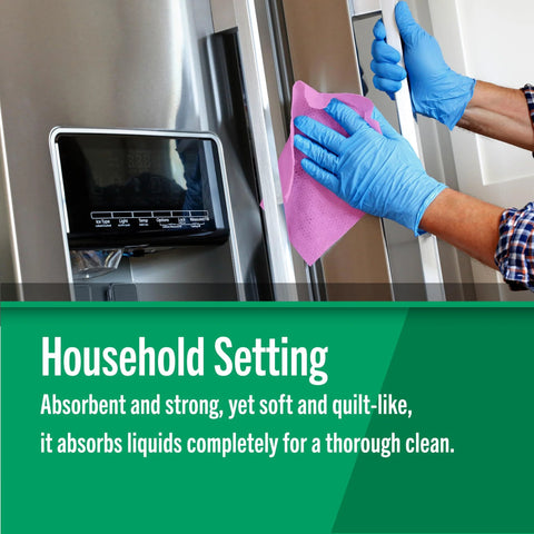 Front view of gloved hands wiping a stainless steel refrigerator with pink Fresh Towel reusable paper towels.
