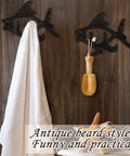 Dead Reliable Cast Iron Fish Wall Hooks 2 Pack holding a towel and bath accessory on rustic wood wall.