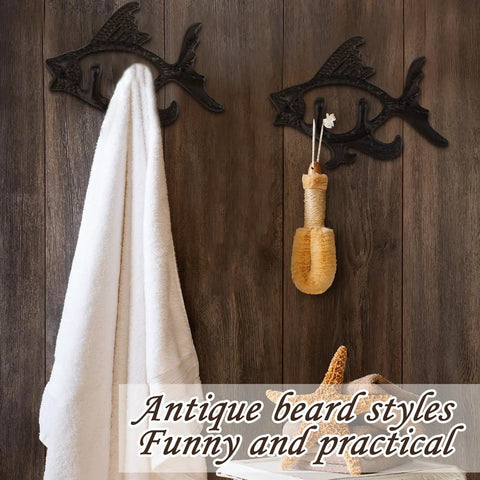 Dead Reliable Cast Iron Fish Wall Hooks 2 Pack holding a towel and bath accessory on rustic wood wall.