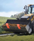Tractor with Beefy Tractor Bucket Edge Protector Set Heavy Duty Steel Guards in orange during leaf cleanup in a field