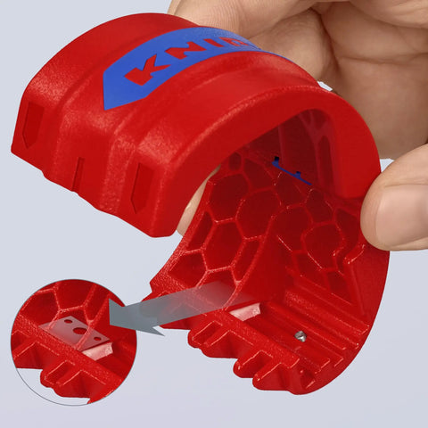 Close-up of red pipe cutter for plastic pipes 20 to 50 mm, shaving-free design, ergonomic handle visible, includes spare blade inset