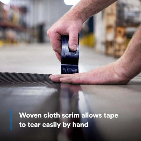 Close-up of hand tearing Heavy Duty Black Duct Tape 1.88 Inch By 60 Yard 3 Pack Industrial Strength Tear By Hand Multi Use