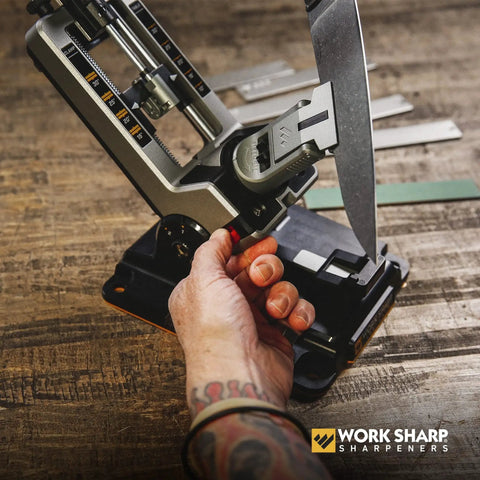 Person using Professional Precision Adjustable Knife Sharpener Kit With Rock Solid Metal Construction For Pocket Hunting Kitchen And Serrated Knives At 15 Degree Angles Includes 7 Diamond Abrasives for sharpening knife.