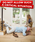 A man fallen on indoor wooden stairs, highlighting the need for Heavy Duty Anti Slip Tape For Stairs Indoor Outdoor Waterproof 4 Inch By 35 Ft Non Skid Adhesive Roll With Boss Level Grip And Traction For Steps Ramps And Treads Black while a woman assists.