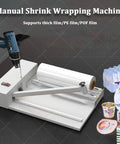 GFJYKDL Professional Shrink Wrap Machine With Heat Gun For Effortless Pvc Pof Pe Film Packaging And Sealing, showing manual operation and roll.