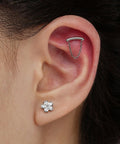 Top Shelf 16G Flower Cartilage Piercing Jewelry In ASTM F136 Titanium, showing helix piercing with chain and flower stud earrings.