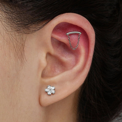 Top Shelf 16G Flower Cartilage Piercing Jewelry In ASTM F136 Titanium, showing helix piercing with chain and flower stud earrings.