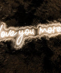 Neon Sign In Transparent Acrylic, Dimmable LED Wall Light That Turns Any Room Into A Cozy Vibe, showing 'love you more' in warm white glow