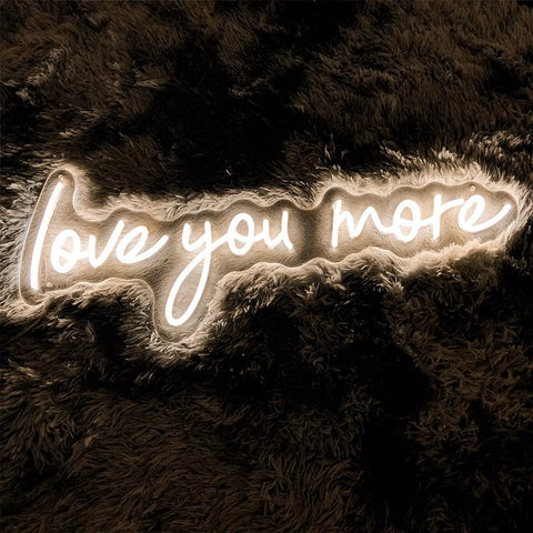 Neon Sign In Transparent Acrylic, Dimmable LED Wall Light That Turns Any Room Into A Cozy Vibe, showing 'love you more' in warm white glow