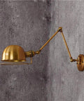 Dope Industrial Telescopic Swing Arm Wall Lamp For Living Room And Loft Vintage Golden Wrought Iron Sconce Adjustable Long Arm E26 E27 Base Creative Decorative Light For Barn Garage Workshop features a sleek vintage golden adjustable arm and dome shade against a textured wall.