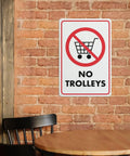 No Trolley Symbol 8 By 12 Warehouse Equipment Restriction Sign for Indoor Outdoor Use on brick wall with chair and table
