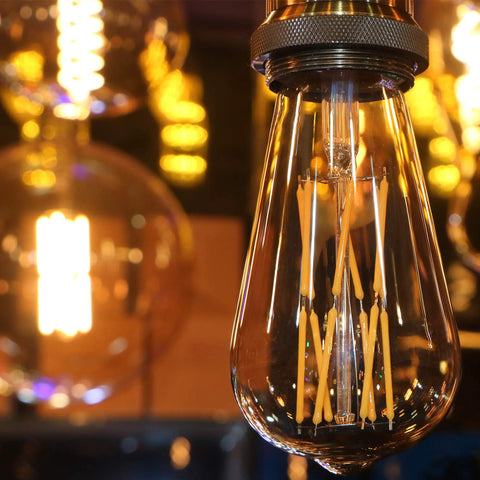 Close-up of Old School Edison Style LED Bulb 10W Dimmable, 100W Equivalent, Clear Glass, Warm White 2700K, E26 Base hanging in fixture