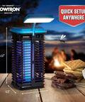 Two In One Solar Powered Bug Zapper With UV Light And LED Lamp on a wooden table, outdoor scene with campfire in background