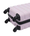 Bottom view of lilac 22-inch hardside spinner luggage with four black wheels