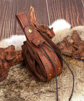 Dual Brown Renaissance Belt Pouch And Viking Bracer Kit Featuring Detachable Waist Bag with leather details on a wooden background.