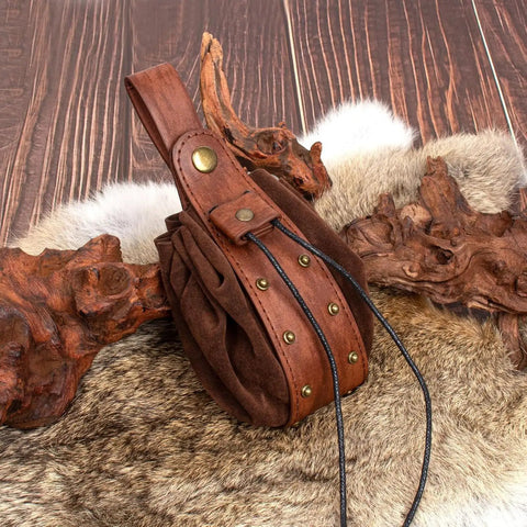 Dual Brown Renaissance Belt Pouch And Viking Bracer Kit Featuring Detachable Waist Bag with leather details on a wooden background.