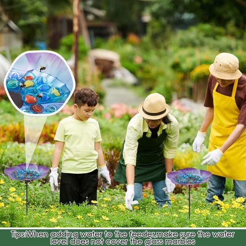 Garden scene with two Vivid Flower Bee Watering Station With Metal Butterfly Water Feeder Cup And 30 Glass Marbles
