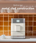 Fully Automatic Espresso Machine With Built In Grinder And Easy Access Bean Hopper, 15 One Touch Recipes For Bold Shots, Creamy Lattes, And Smooth Americano, Porcelain White Coffee Maker That Is A Legit Game Changer For Your Daily Grind on kitchen counter with metal clad finish.