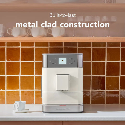 Fully Automatic Espresso Machine With Built In Grinder And Easy Access Bean Hopper, 15 One Touch Recipes For Bold Shots, Creamy Lattes, And Smooth Americano, Porcelain White Coffee Maker That Is A Legit Game Changer For Your Daily Grind on kitchen counter with metal clad finish.
