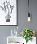 One Light Pendant With Matte Black Finish, Black Woven Fabric Cord, E26 Base Socket, Adjustable Hanging Length in a modern room