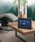 7 In 1 Wi Fi Solar Weather Station With 7 Inch Color Display on wooden table in modern living room with forest view