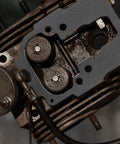 Close-up view of automotive engine cylinder head with gasket surface and valve seats.