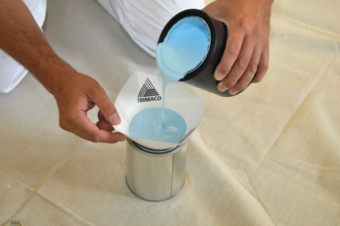 Man pouring blue paint through Durable Polyester Cone Paint And Stain Strainers, Fine Mesh 190 Micron, Easy Pour Cone Design