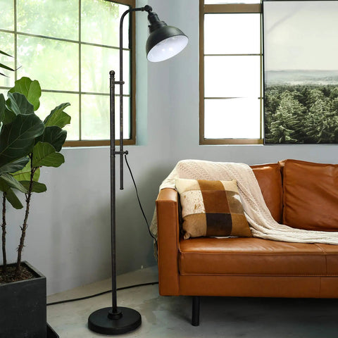 Tall Industrial Floor Lamp With Adjustable Height And Head next to orange sofa in living room with large window view