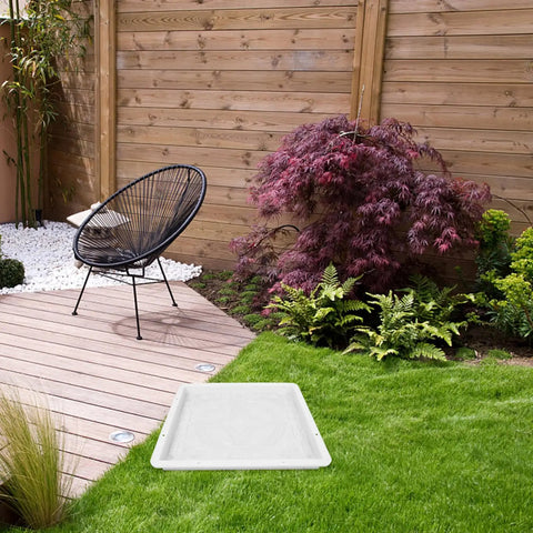 Garden scene with Path Maker Paver Mold For Garden, Reusable Outdoor Pavement Mold on grass near a wooden patio and chair