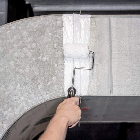 Applying Patch And Seal Liquid Rubber Waterproof Sealant White 32 Ounce with roller on metal surface to seal out moisture